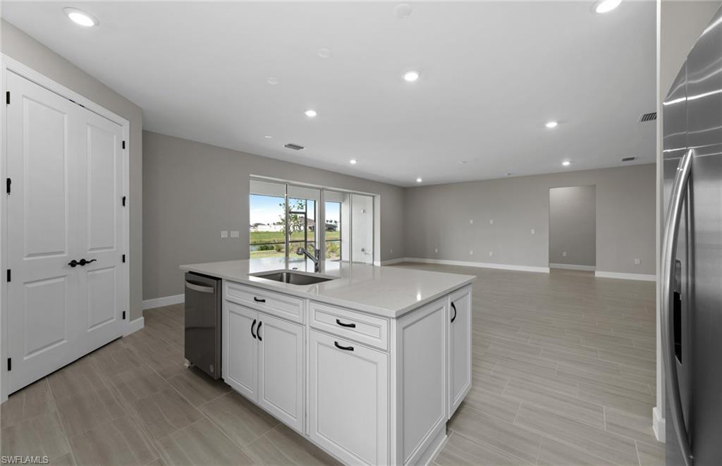 42533 Little Ridge Road Punta Gorda, FL 33982 - Photo 29 of 50 a view of a kitchen with a sink and dishwasher with wooden floor
