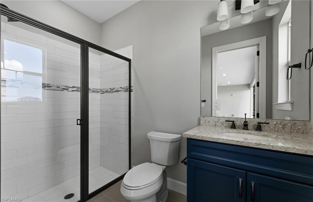 42533 Little Ridge Road Punta Gorda, FL 33982 - Photo 41 of 50 a bathroom with a granite countertop sink toilet and shower