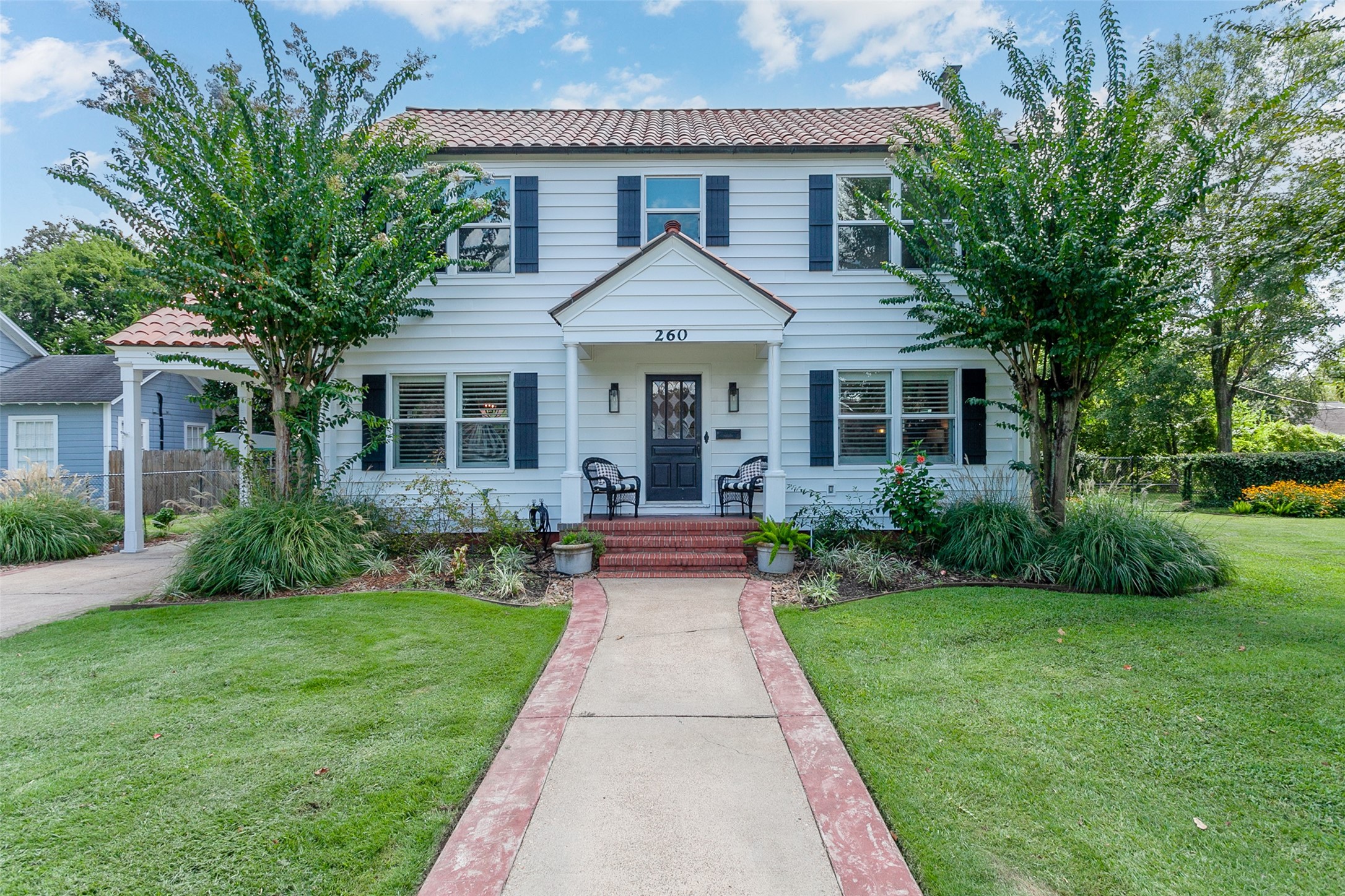 a front view of house with yard and green space