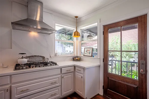 a kitchen with a stove a sink and a window