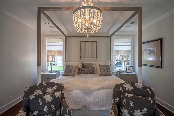 a bedroom with a bed and a chandelier