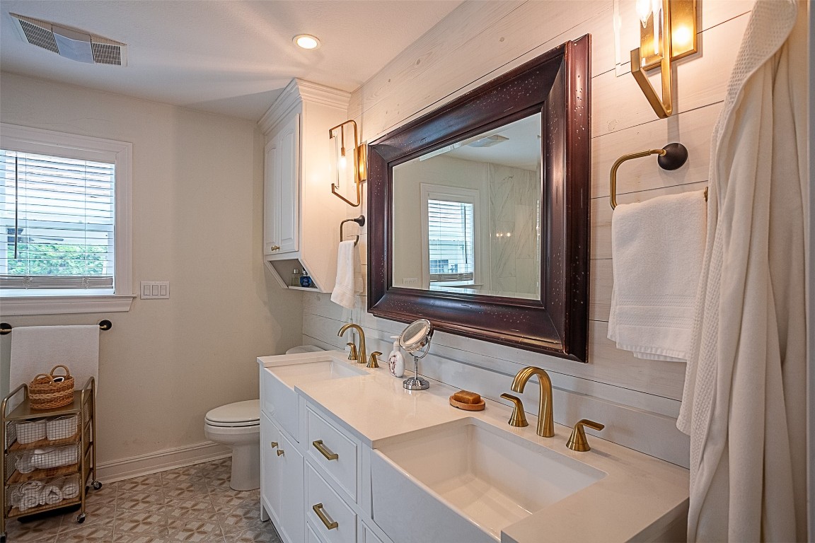 260 Manor Street Beaumont, TX 77706 - Photo 25 of 50 a bathroom with a sink double vanity and a toilet