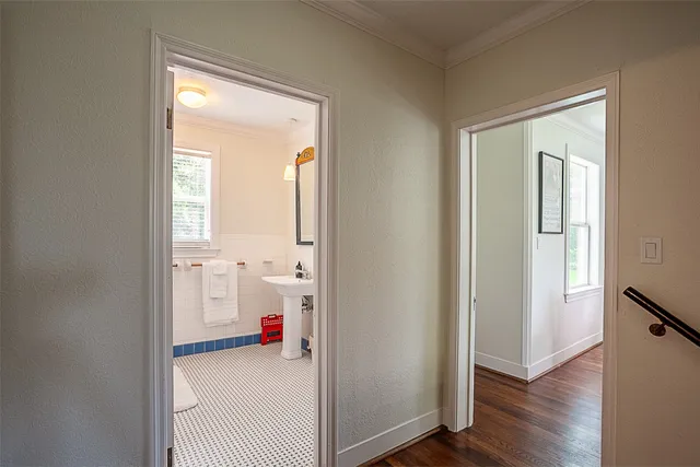 a view of a room that has a window and wooden floor