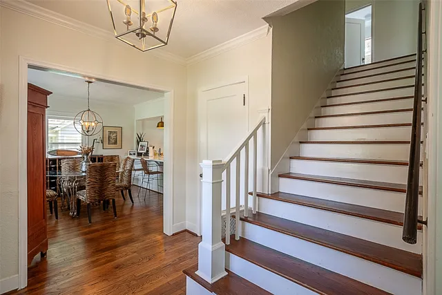 a view of a livingroom with wooden floor and furniture