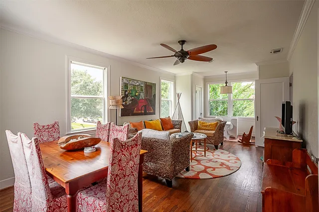 a living room with furniture a large window and a flat screen tv