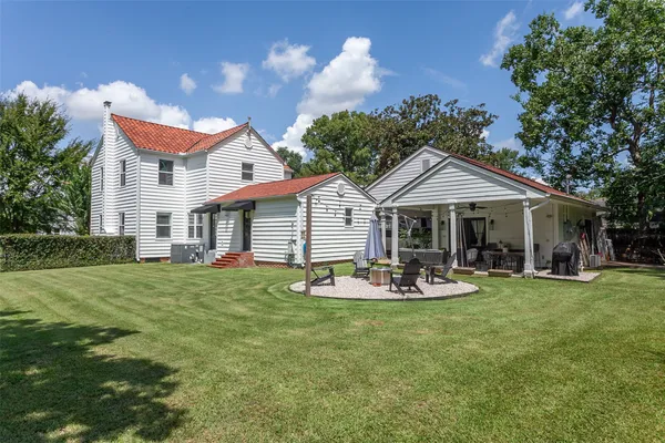 a front view of a house with a garden and patio