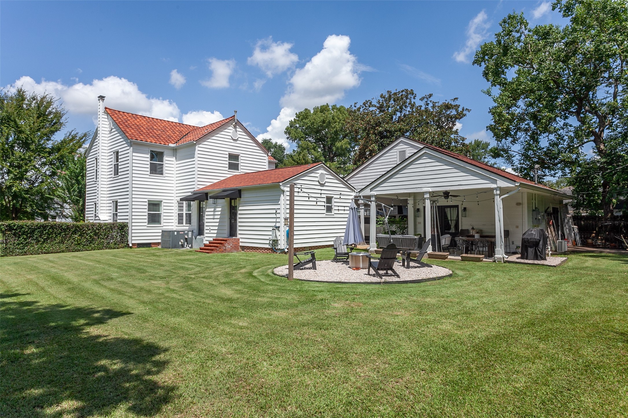 260 Manor Street Beaumont, TX 77706 - Photo 4 of 50 a front view of a house with a garden and patio
