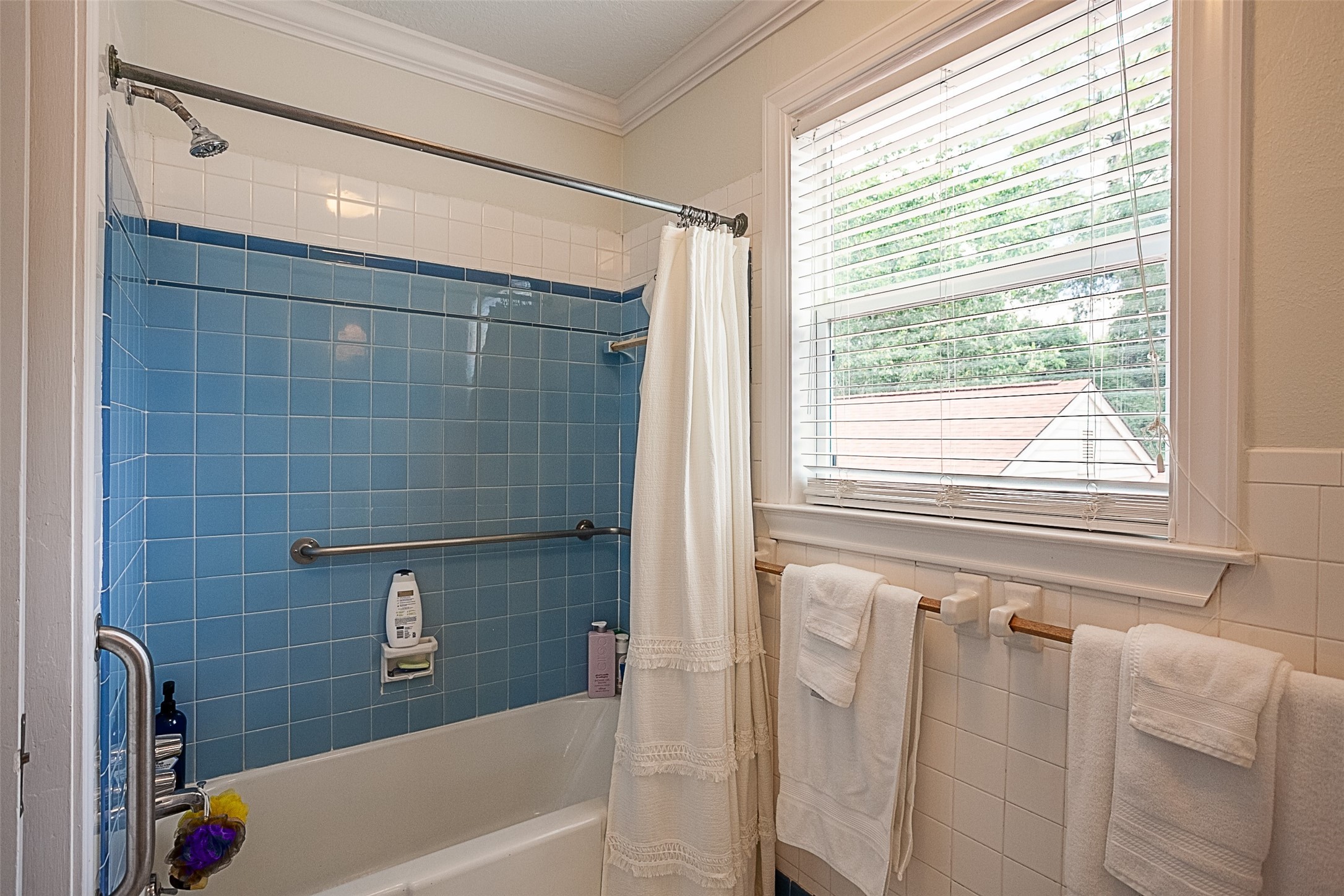 260 Manor Street Beaumont, TX 77706 - Photo 41 of 50 a bathroom with a bathtub a shower and a window