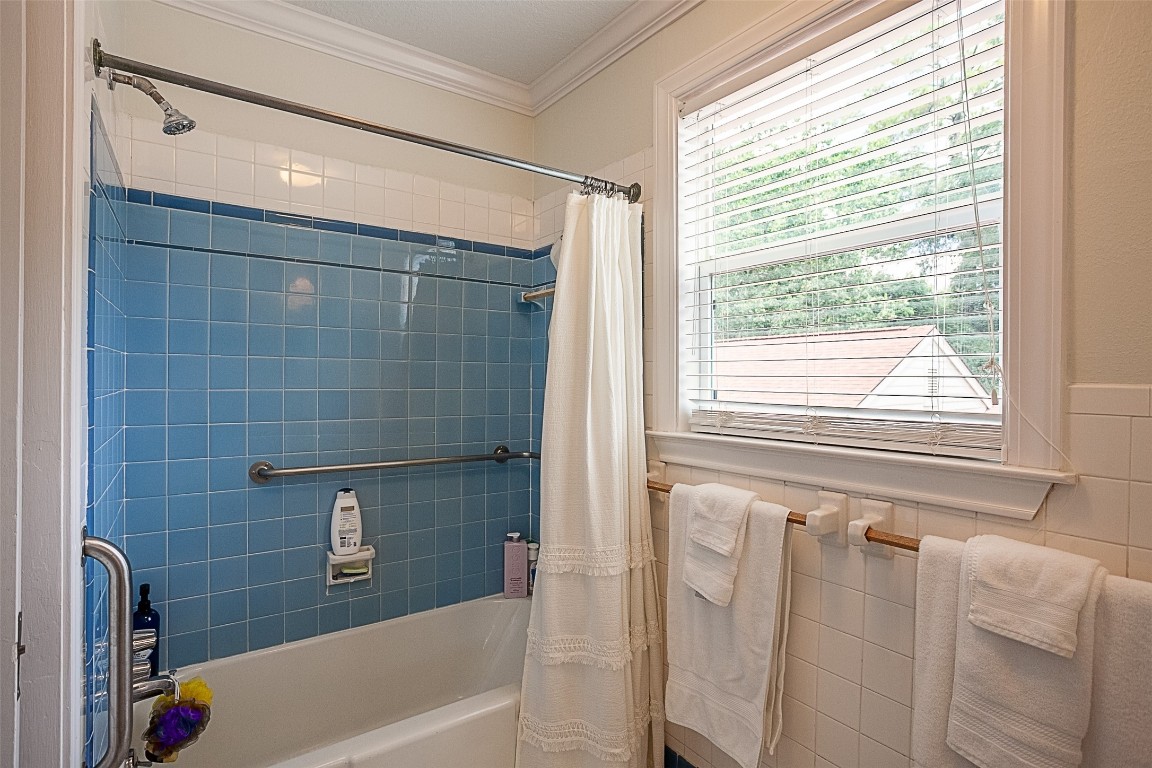 260 Manor Street Beaumont, TX 77706 - Photo 41 of 50 a bathroom with a bathtub a shower and a window