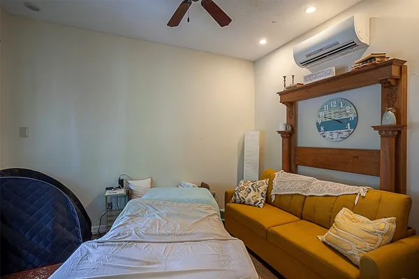 a bedroom with a bed and flat screen tv