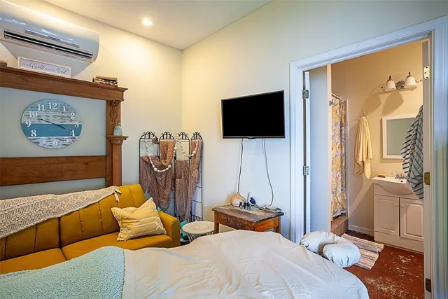 a bathroom with a sink a toilet a mirror and shower curtain