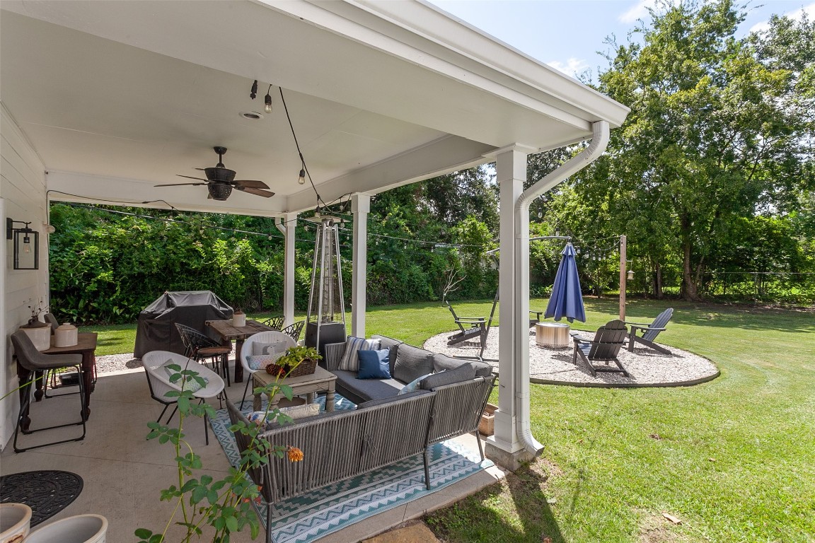 260 Manor Street Beaumont, TX 77706 - Photo 5 of 50 a view of a patio with a table chairs and a backyard