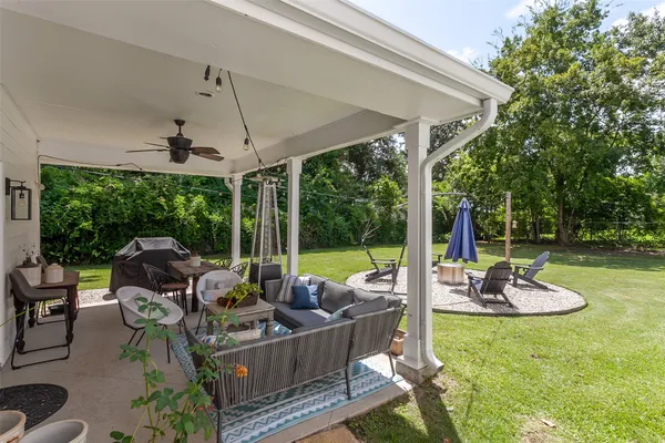a view of a patio with a table chairs and a backyard