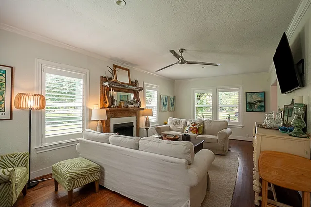 a living room with furniture a flat screen tv and a fireplace