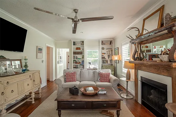 a living room with furniture a flat screen tv and a fireplace