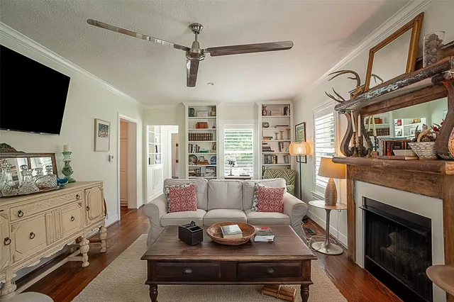 a living room with furniture a flat screen tv and a fireplace