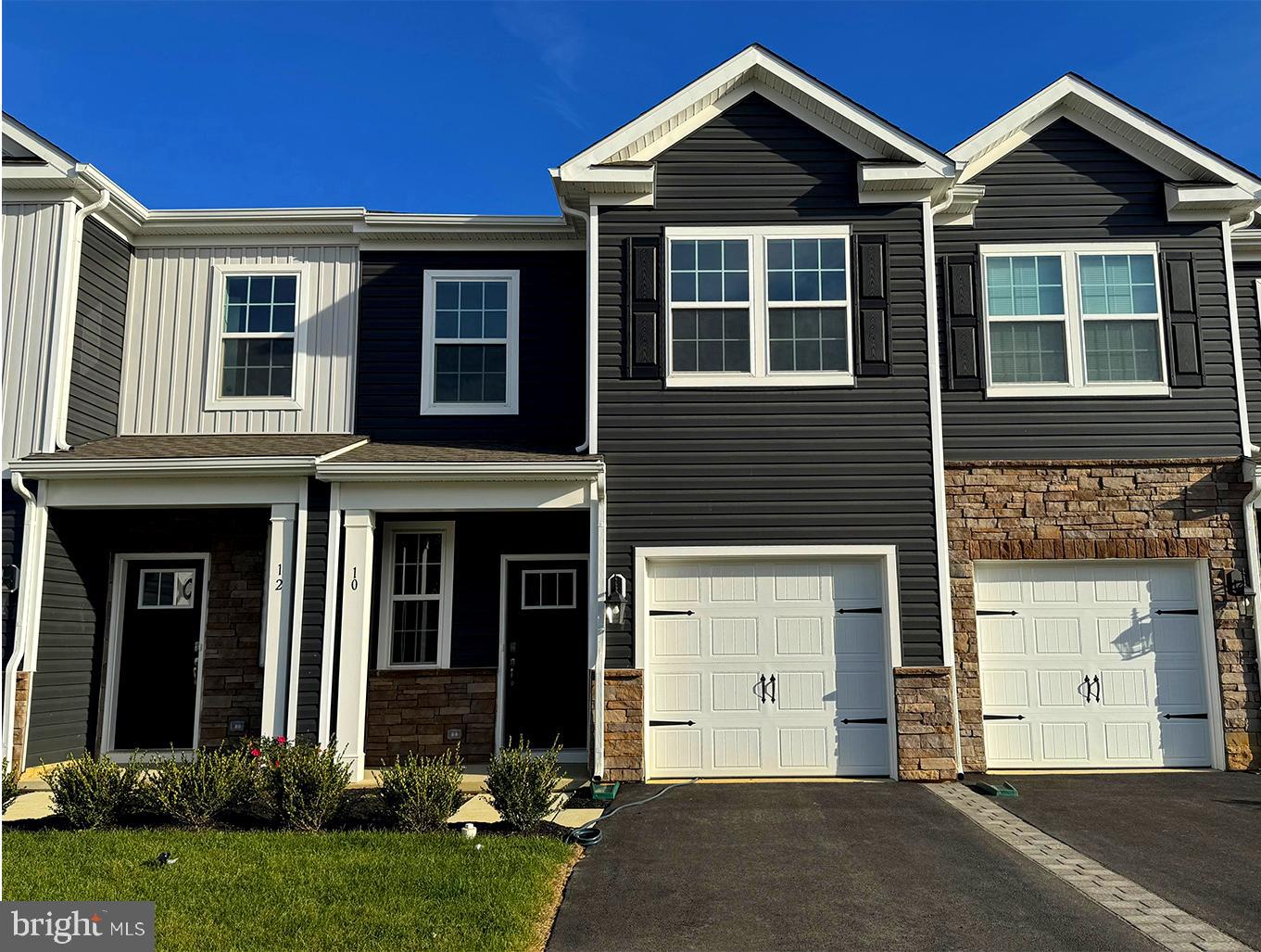a view of a brick house with a yard