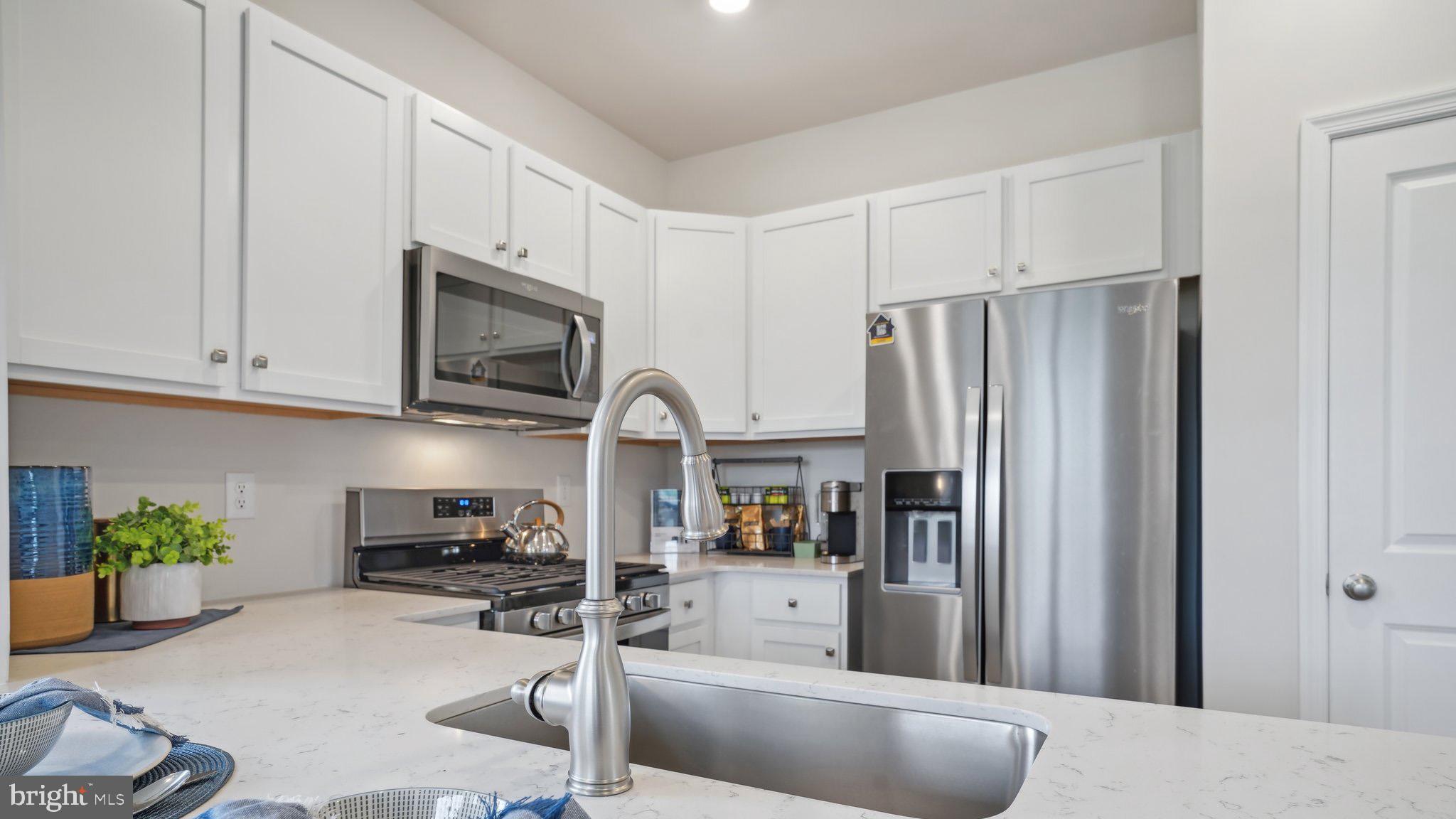 5 Eleanor Lane Roosevelt, NJ 08555 - Photo 10 of 25 a kitchen with stainless steel appliances a refrigerator a sink a stove and cabinets