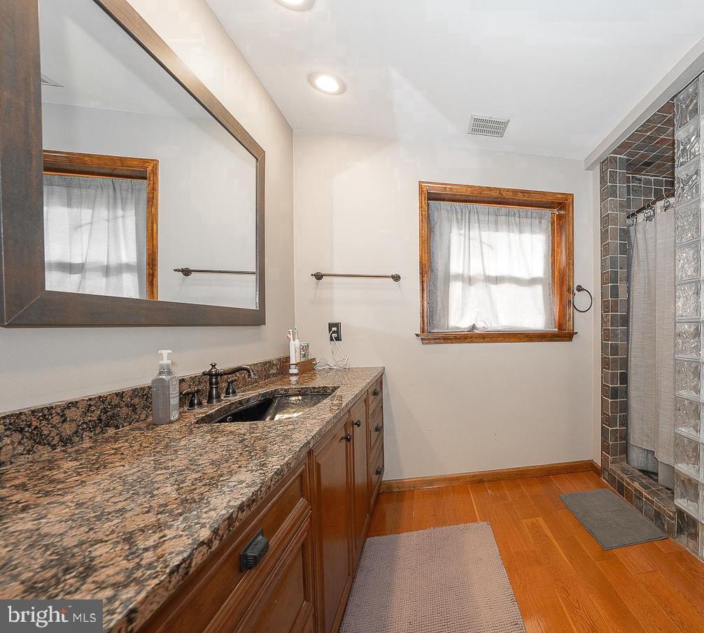 612 Manayunk Road Merion Station, PA 19066 - Photo 28 of 48 a bathroom with a granite countertop sink and a mirror