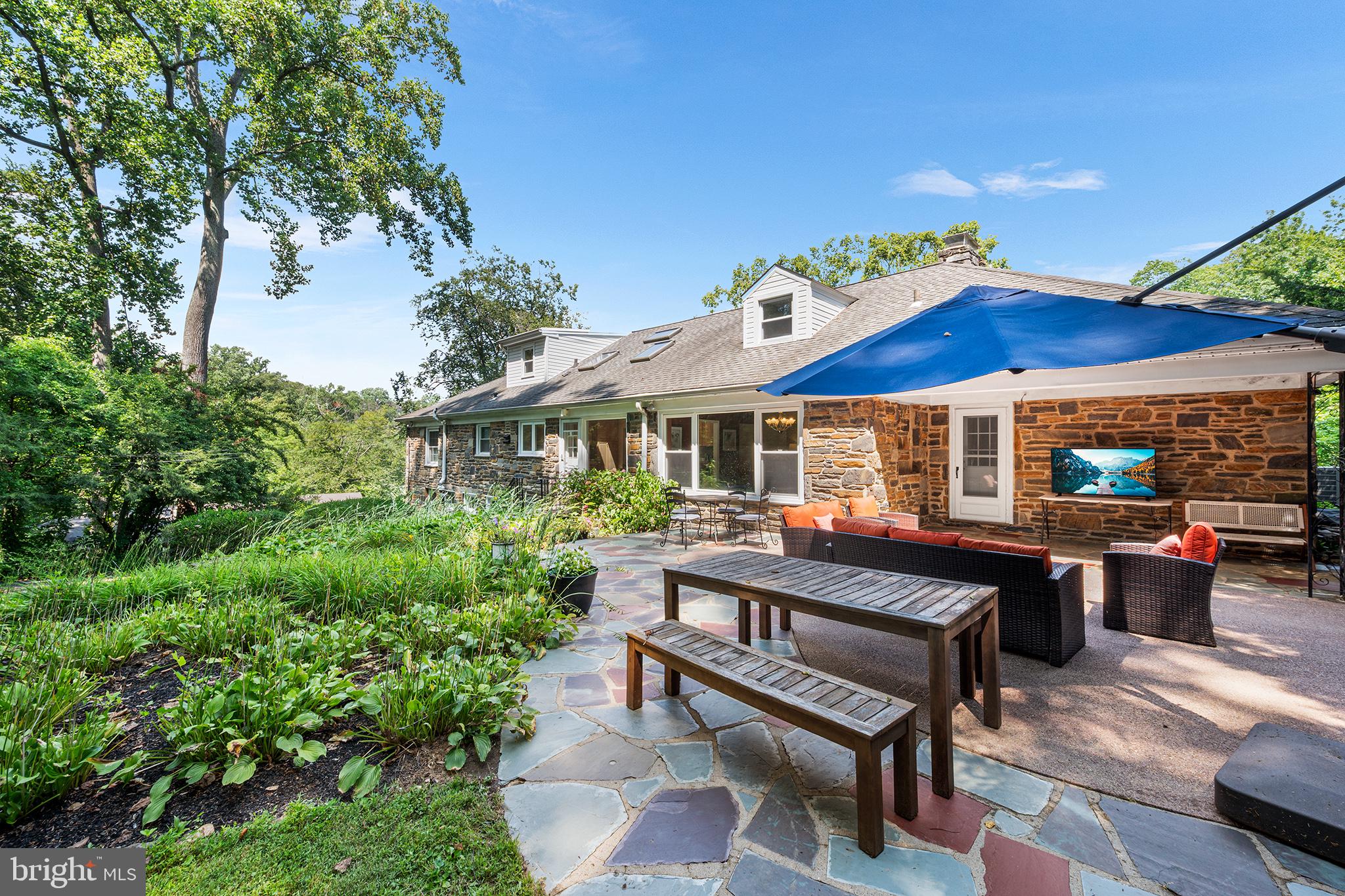 612 Manayunk Road Merion Station, PA 19066 - Photo 5 of 48 a view of a house with backyard sitting area and garden