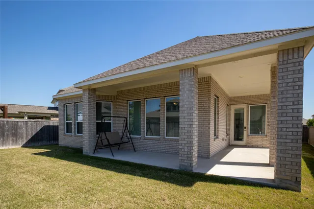 a view of a house with a backyard
