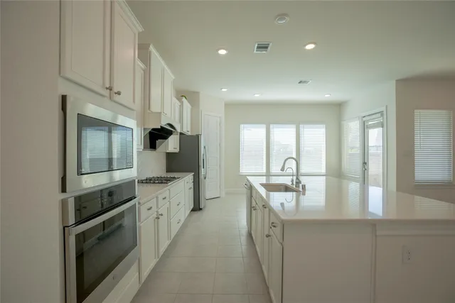 a kitchen with counter top space cabinets and stainless steel appliances