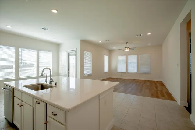 a kitchen with kitchen island a sink appliances and a counter top space