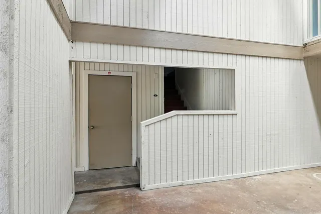 a view of a hallway with wooden shelves