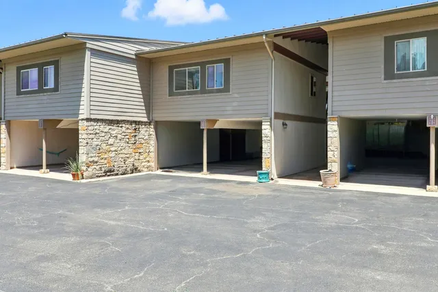 a view of a house with a yard and garage