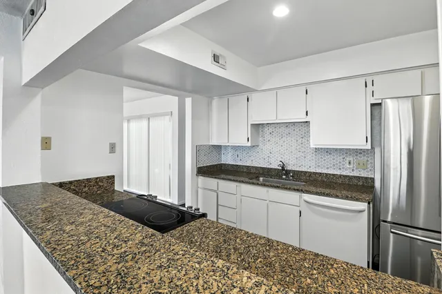 a kitchen with a refrigerator and a sink