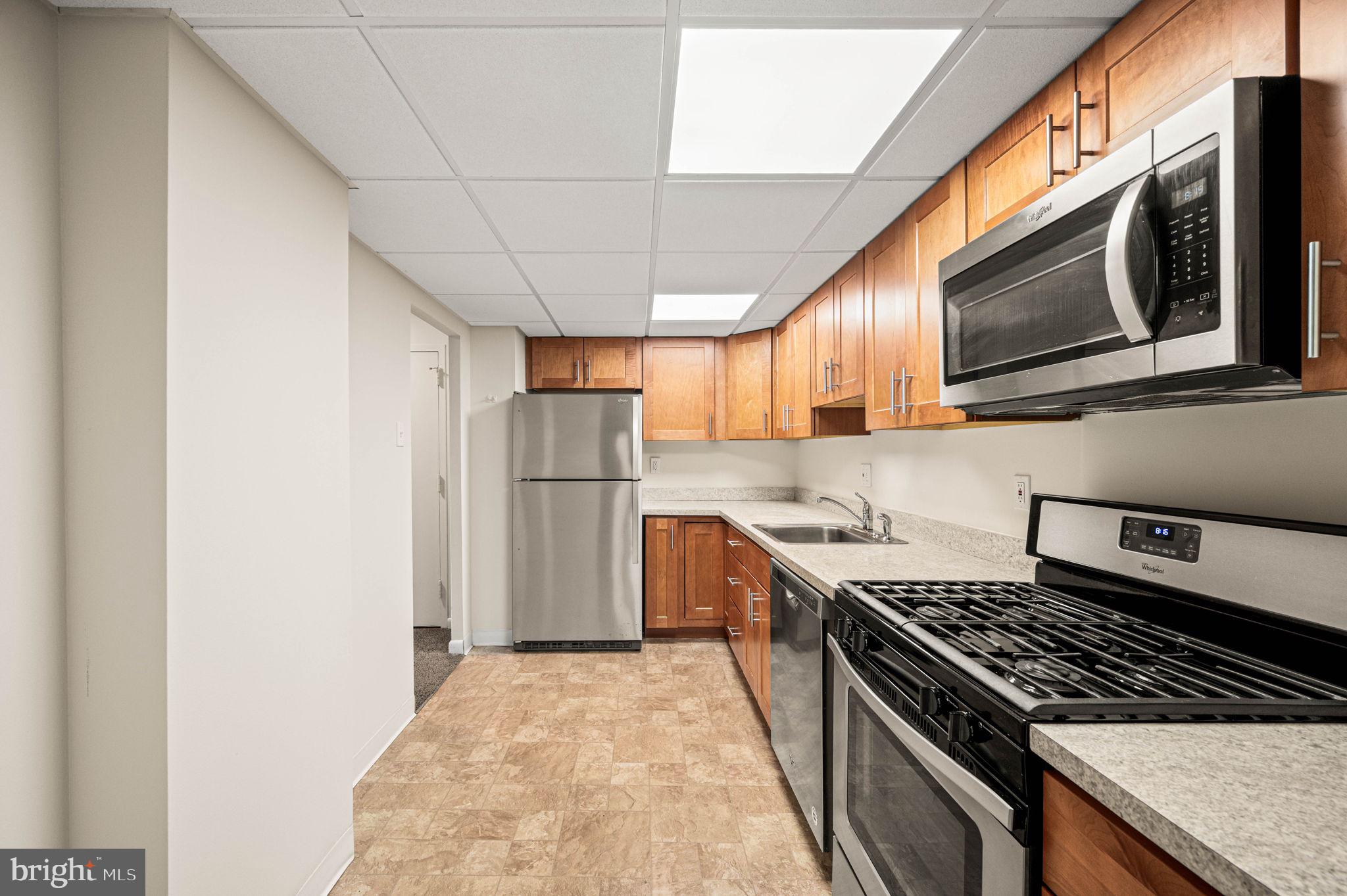 801 Yale Avenue, Unit 610 Swarthmore, PA 19081 - Photo 12 of 39 Kitchen hardwood cabinets.