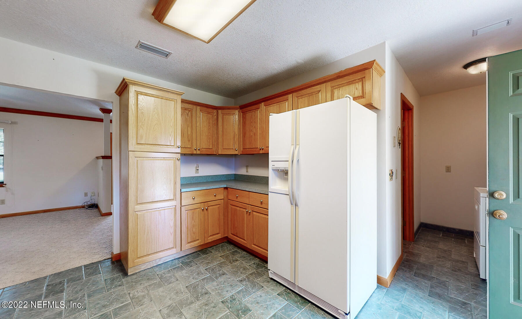 45918 Bismark Road Callahan, FL 32011 - Photo 14 of 45 a kitchen with stainless steel appliances a refrigerator sink and cabinets