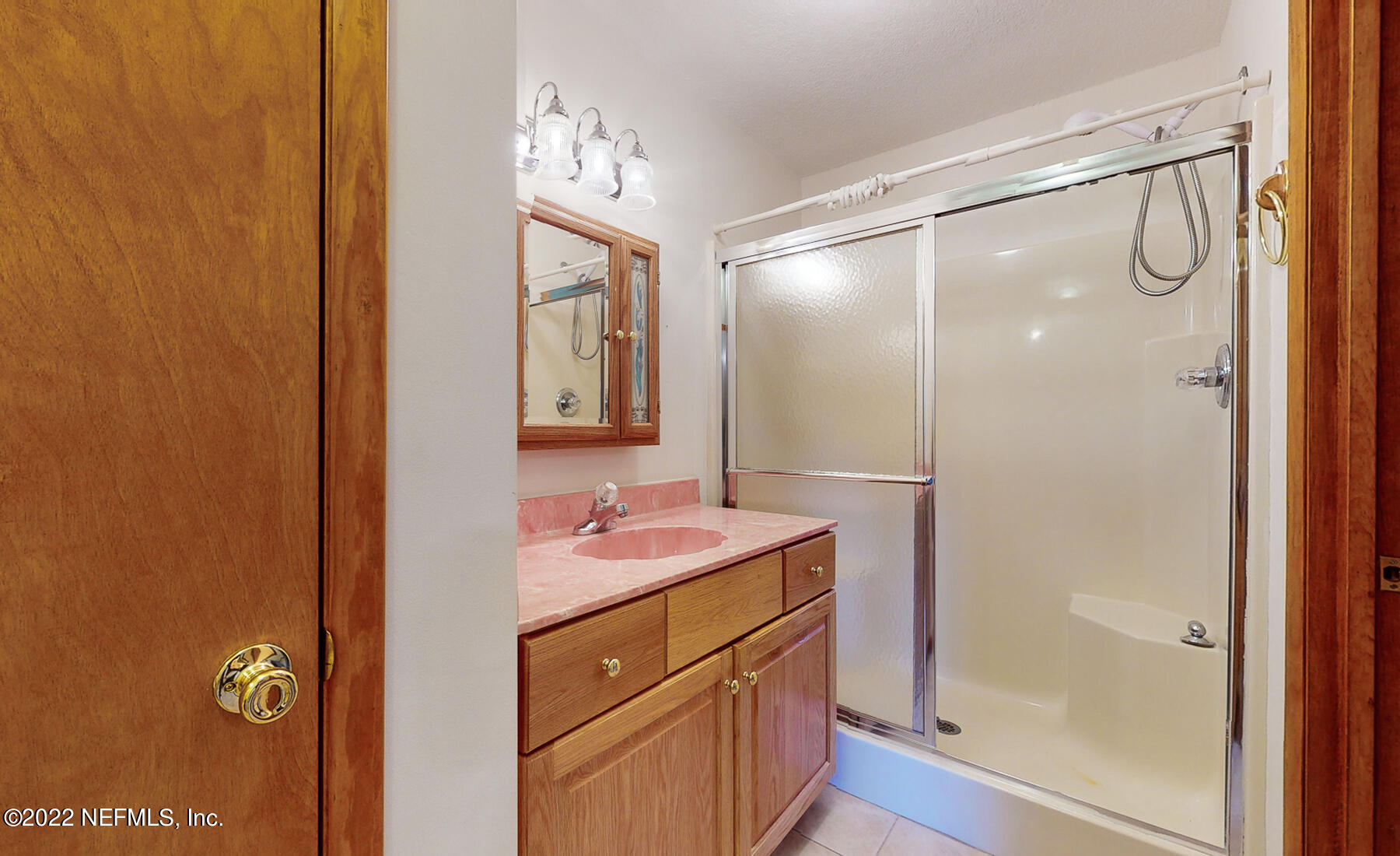 45918 Bismark Road Callahan, FL 32011 - Photo 25 of 45 a bathroom with a sink mirror and a shower