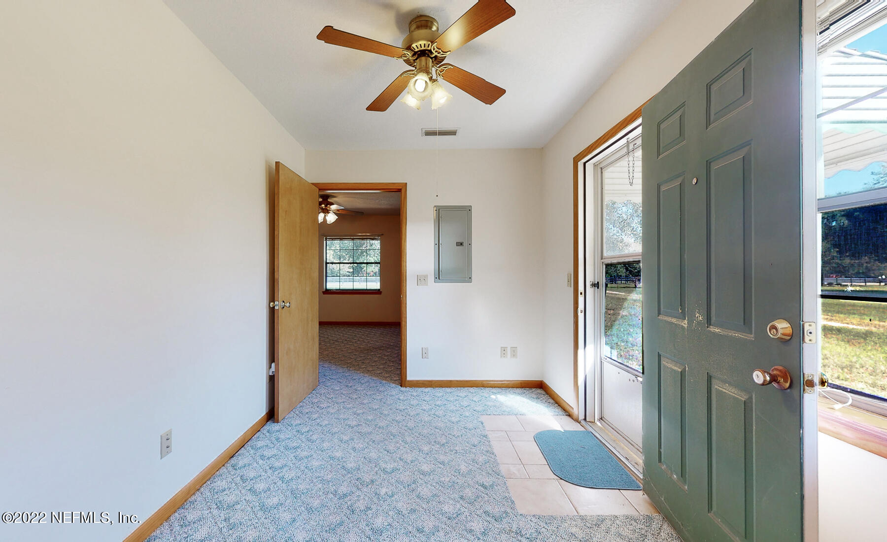 45918 Bismark Road Callahan, FL 32011 - Photo 29 of 45 a view of a hallway with wooden floor and a chandelier fan