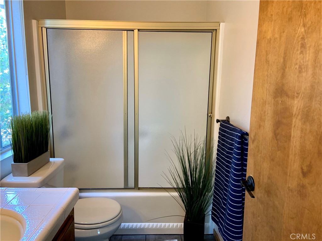 5507 Zermatt Drive Wrightwood, CA 92397 - Photo 18 of 31 a bathroom with a toilet a sink and mirror