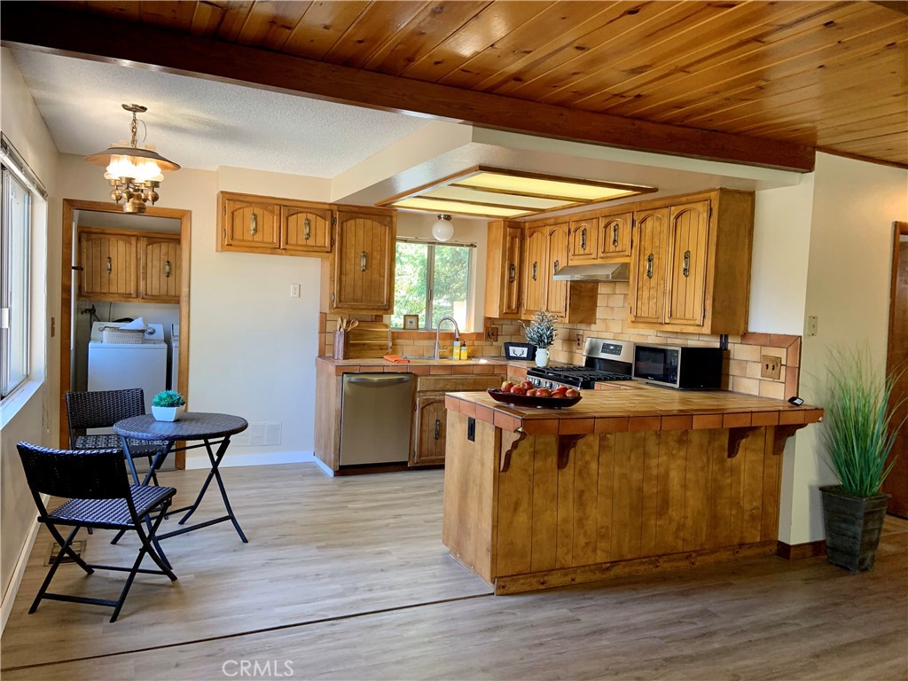 5507 Zermatt Drive Wrightwood, CA 92397 - Photo 8 of 31 a living room with stainless steel appliances kitchen island granite countertop furniture and a large window