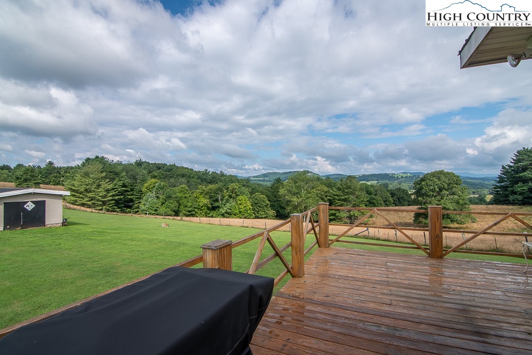 2411 Glade Valley Road Sparta, NC 28675 - Photo 23 of 50 a view of a terrace with wooden floor and a yard