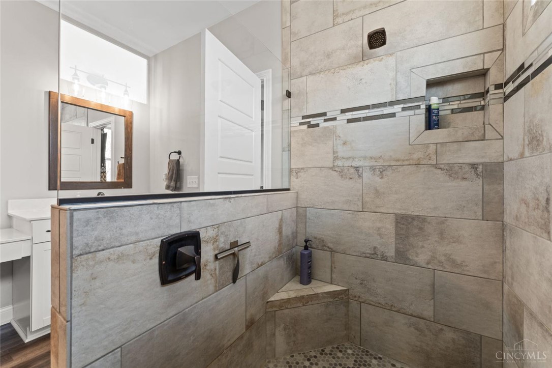 2425 Middleboro Road Clarksville, OH 45113 - Photo 71 of 91 This bathroom offers a large shower space with built-in shelving, perfect for modern living.