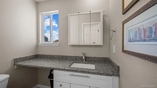a kitchen with granite countertop cabinets stainless steel appliances and a sink