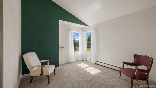 a view of a livingroom with chair and couch
