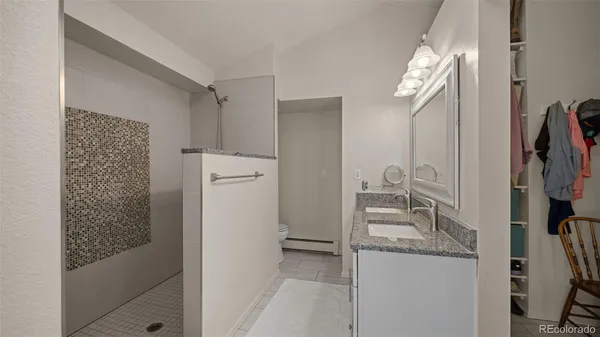 a bathroom with a granite countertop sink and a mirror