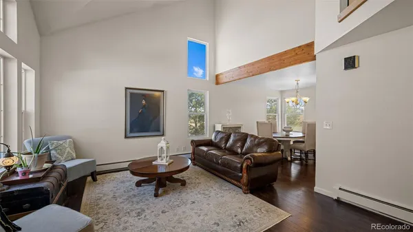 a living room with furniture rug and wooden floor