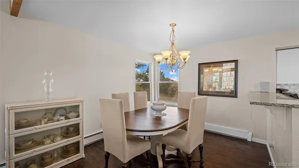 a dining room with furniture a chandelier and window