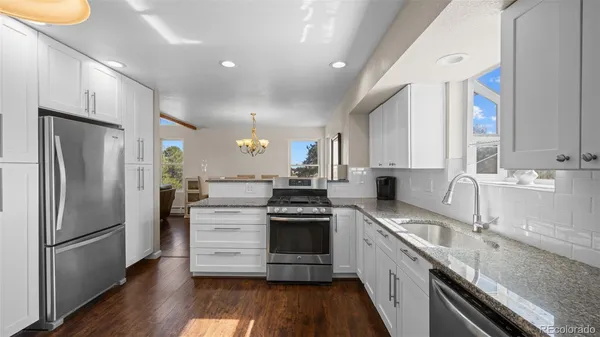 a kitchen with a sink stainless steel appliances and cabinets