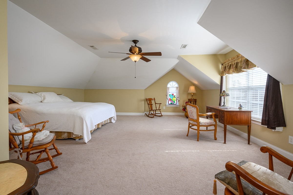 7116 Fernvale Road Fairview, TN 37062 - Photo 25 of 38 a bedroom with furniture and a chandelier