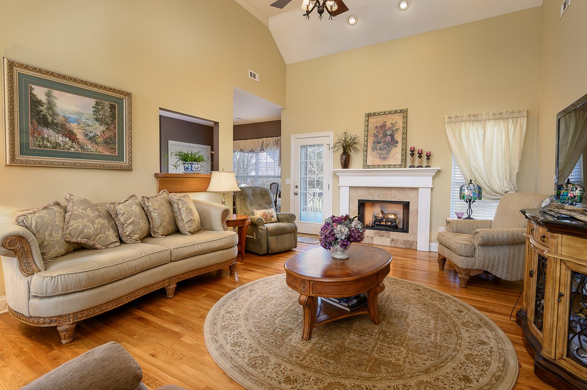 7116 Fernvale Road Fairview, TN 37062 - Photo 8 of 38 a living room with furniture a rug and a fireplace