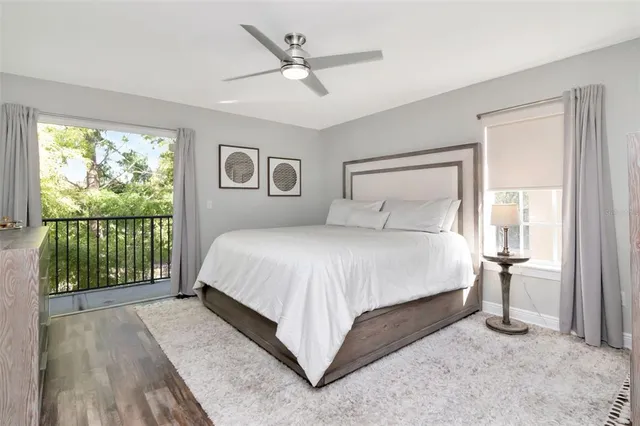 a bedroom with a large bed and a large window