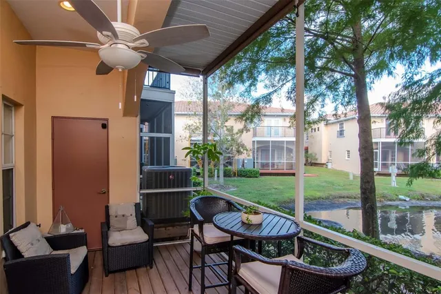 a view of a porch with furniture and a yard