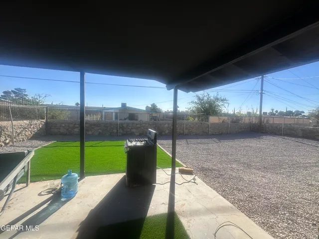 a view of a backyard with sitting area