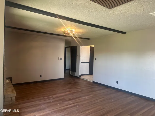 a view of a room with wooden floor